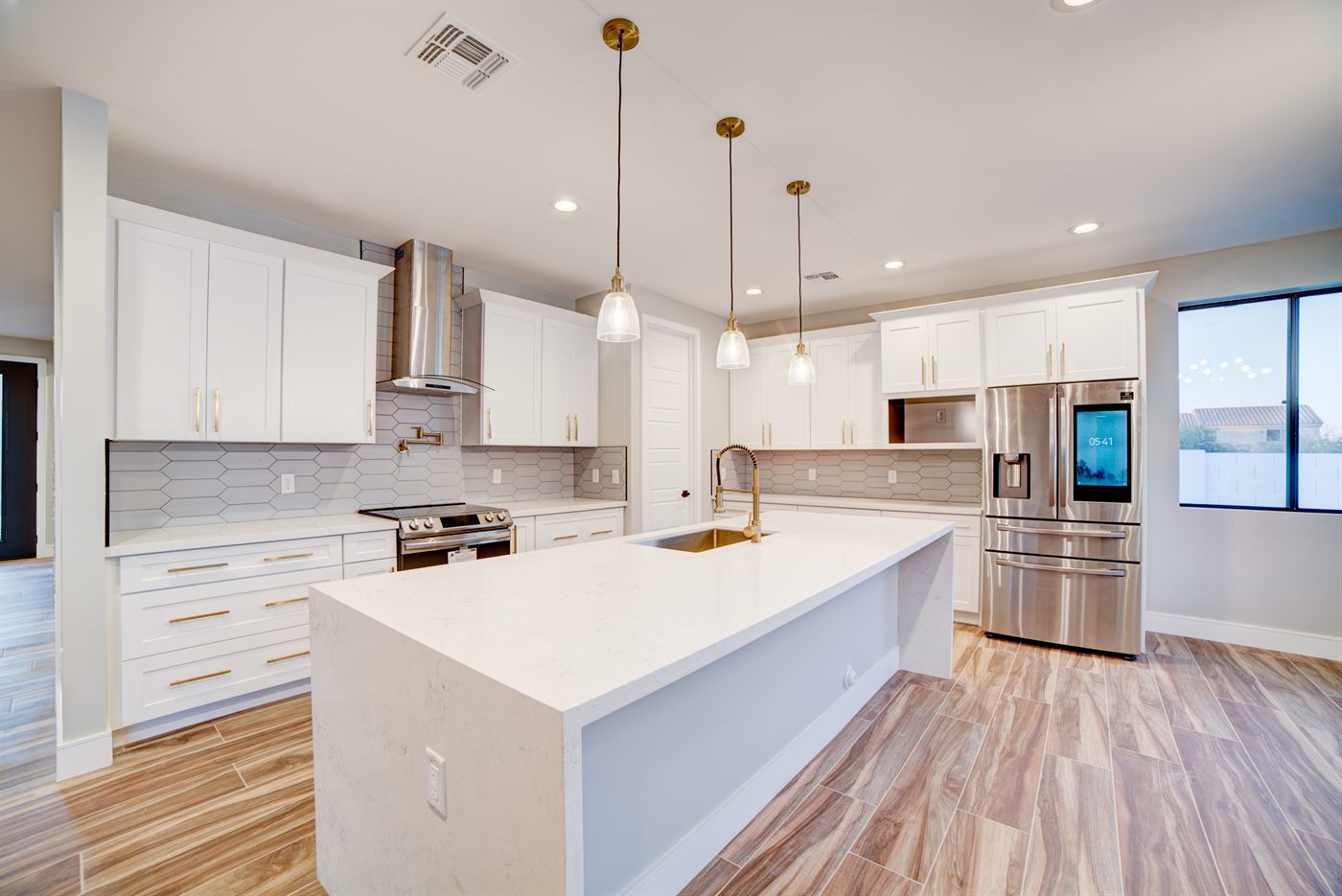 Remodeled kitchen with white cabinetry and island