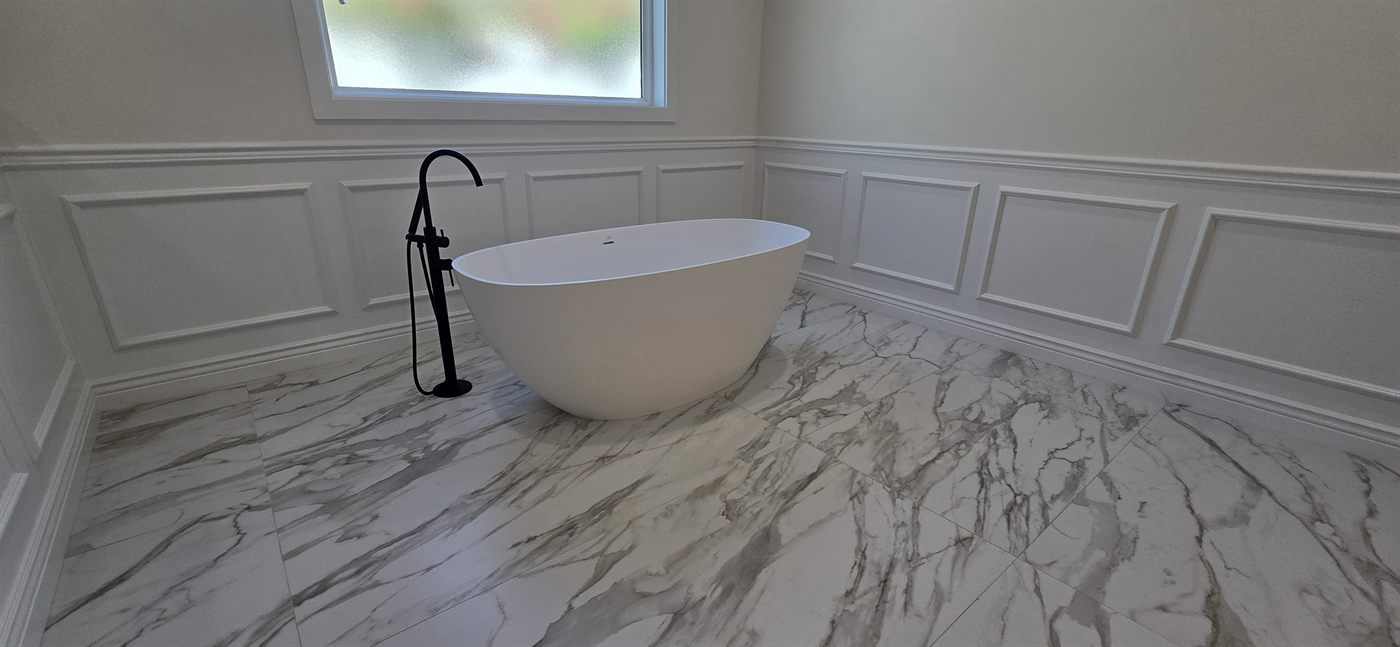 Custom wainscoting millwork with freestanding tub